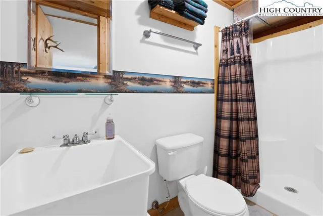 a white toilet sitting next to a bathroom sink