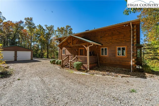 a view of a house with a yard and wooden fence