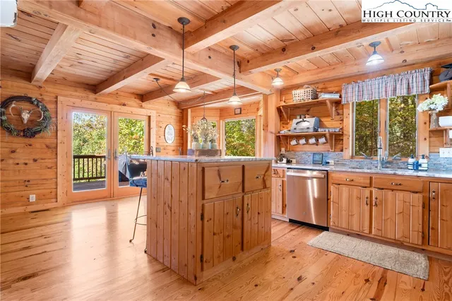 a view of a kitchen with furniture and wooden floor