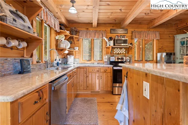 a kitchen with stainless steel appliances granite countertop a sink and cabinets