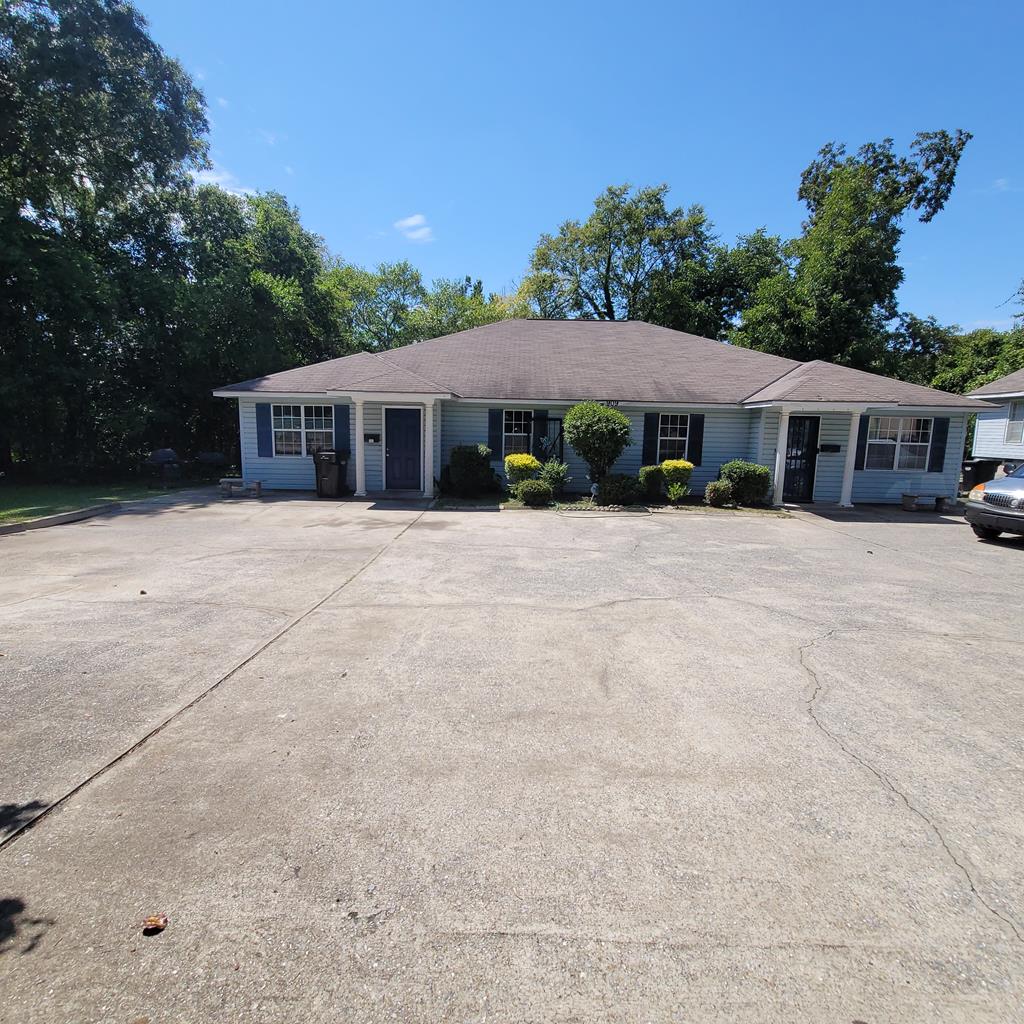 909 Washington Avenue, Unit 1 Columbus, GA 31906 - Photo 1 of 10 a backyard of a house with yard and outdoor seating