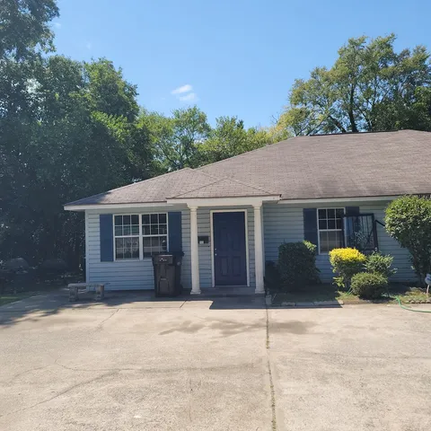 a house that has a tree in front of it