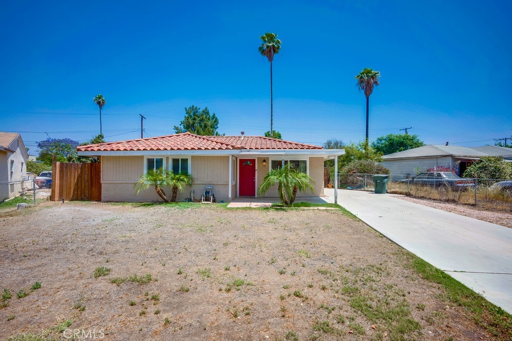 8365 Greenpoint Avenue Riverside, CA 92503 - Photo 1 of 1 a front view of a house with a yard and potted plants