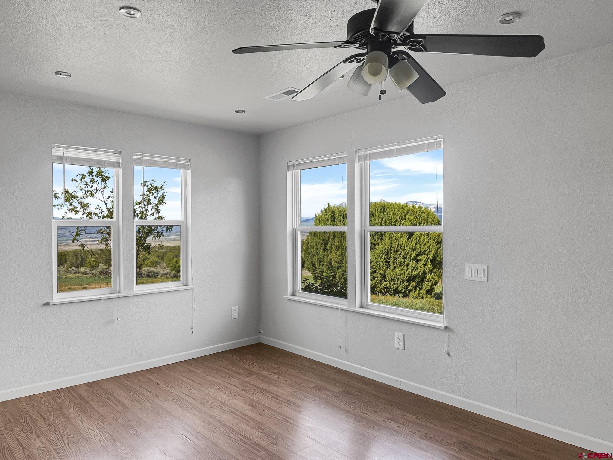 32310 B50 Road Crawford, CO 81415 - Photo 18 of 45 a view of an empty room with a window and wooden floor