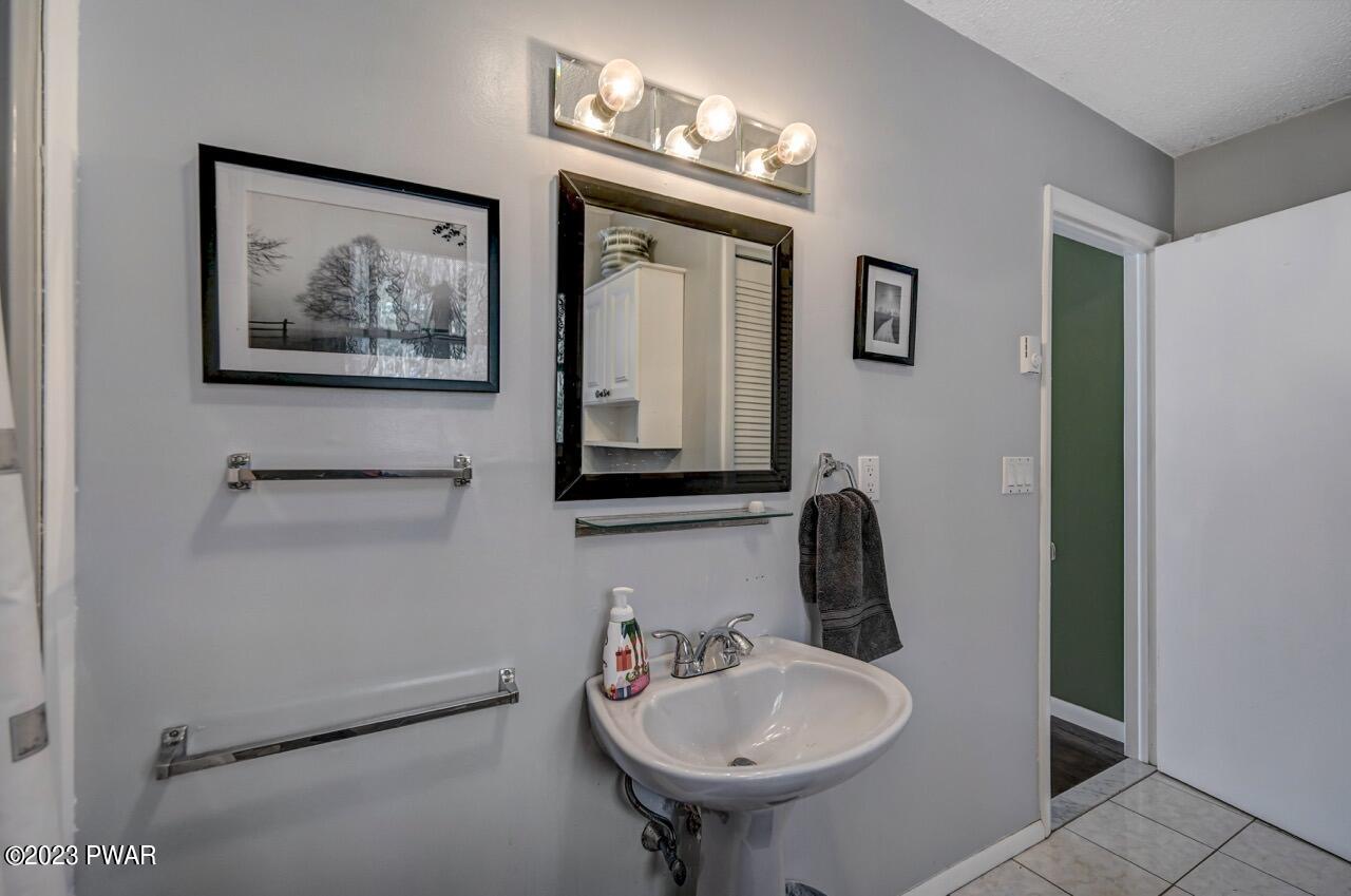 3041 Northgate Road Lake Ariel, PA 18436 - Photo 23 of 98 a bathroom with a sink and a mirror