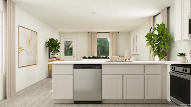 a kitchen with cabinets and window