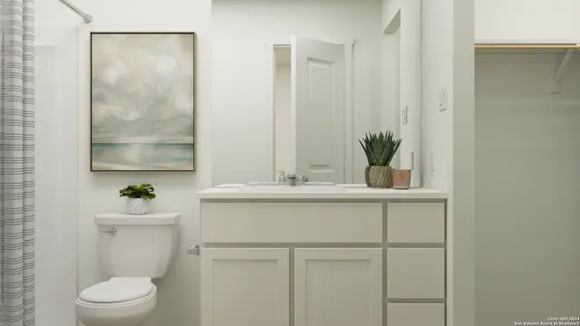 a bathroom with a sink a toilet and a mirror