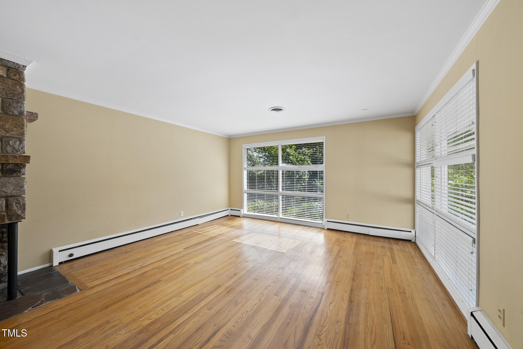 825 Woodburn Road Raleigh, NC 27605 - Photo 14 of 35 a view of an empty room with wooden floor and a window
