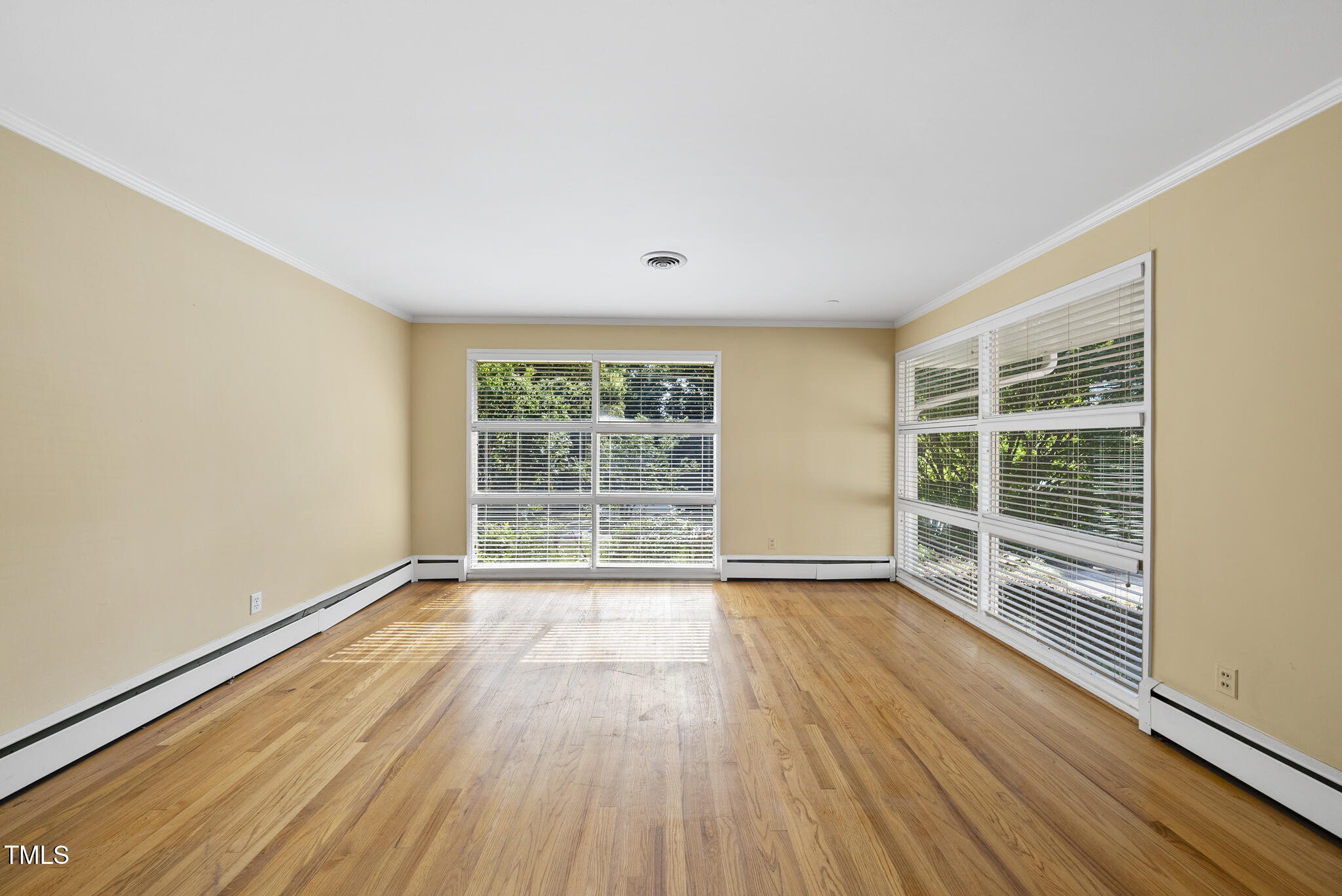 825 Woodburn Road Raleigh, NC 27605 - Photo 15 of 35 a view of an empty room with wooden floor and a window