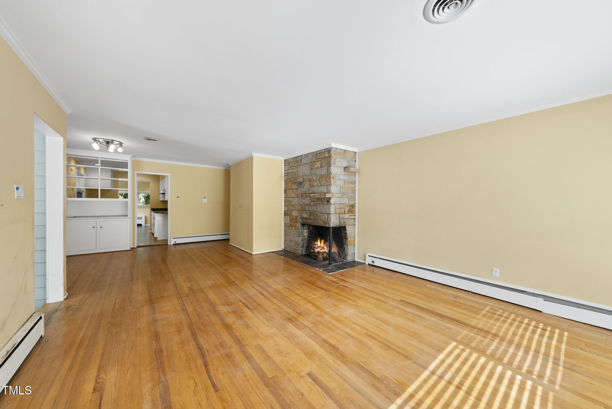 825 Woodburn Road Raleigh, NC 27605 - Photo 16 of 35 a view of empty room with wooden floor and fireplace