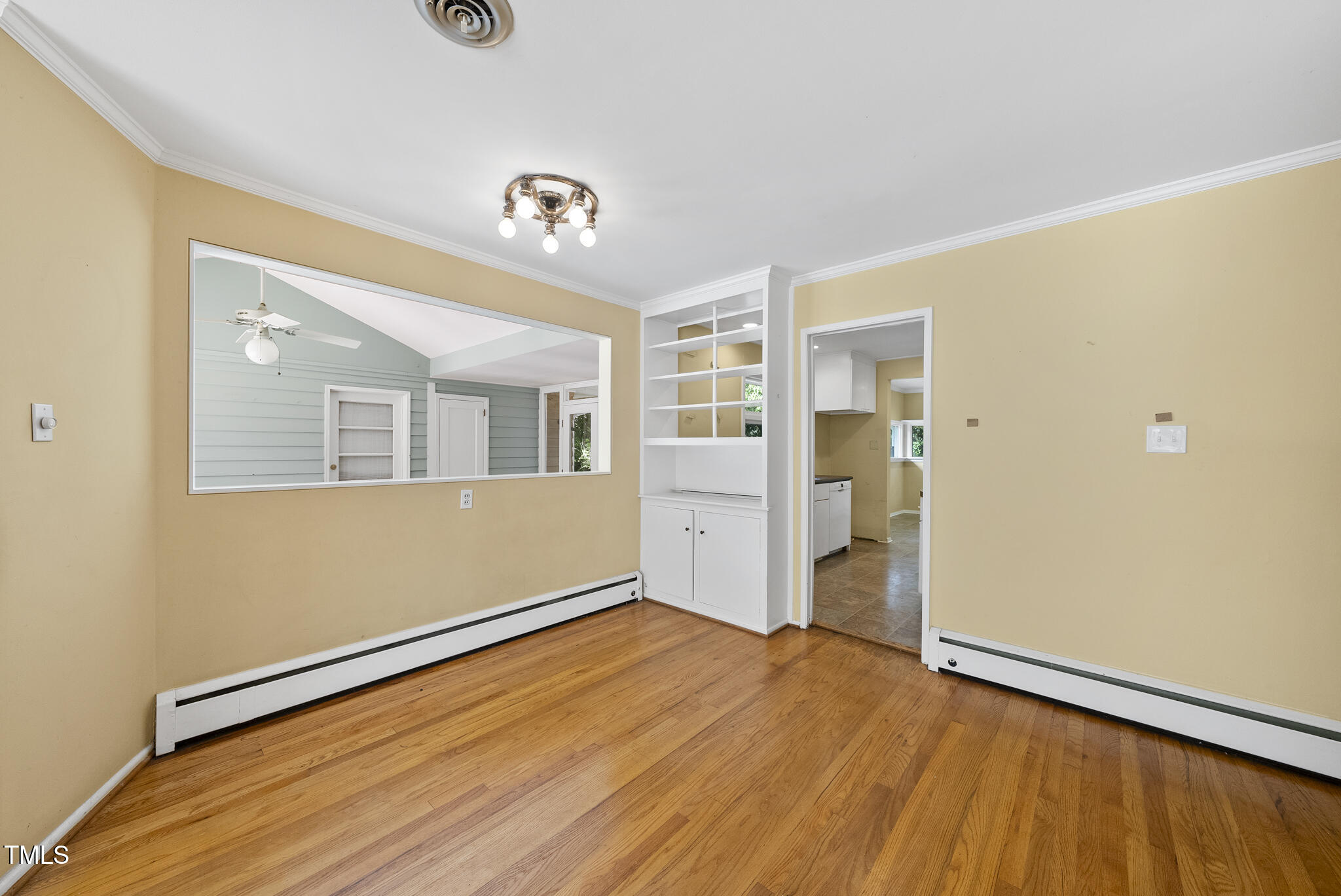 825 Woodburn Road Raleigh, NC 27605 - Photo 17 of 35 a view of an empty room with wooden floor and a window