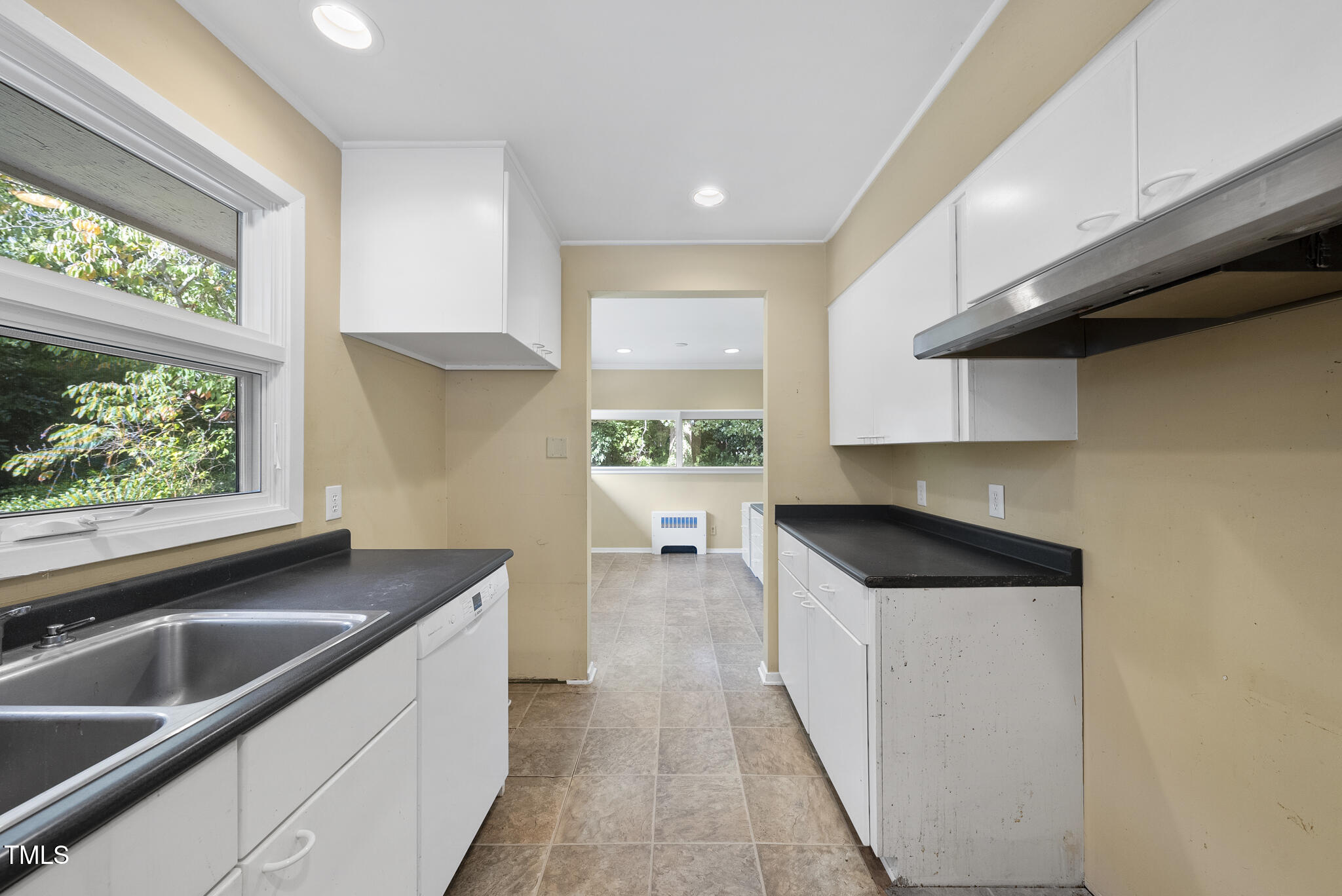 825 Woodburn Road Raleigh, NC 27605 - Photo 19 of 35 a kitchen with a sink a stove and cabinets