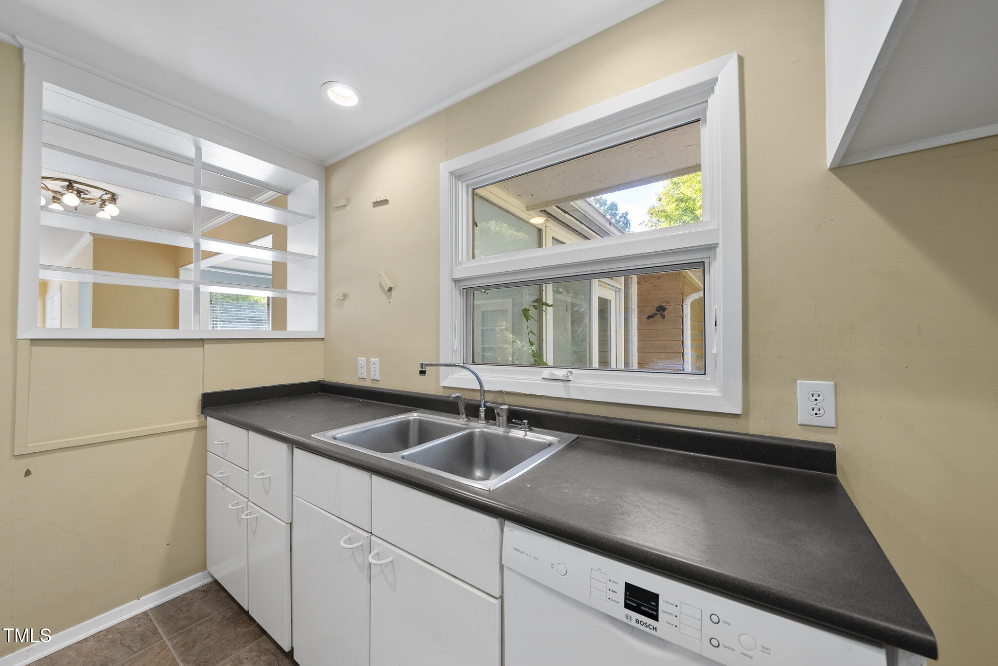 825 Woodburn Road Raleigh, NC 27605 - Photo 20 of 35 a kitchen with a sink and large window