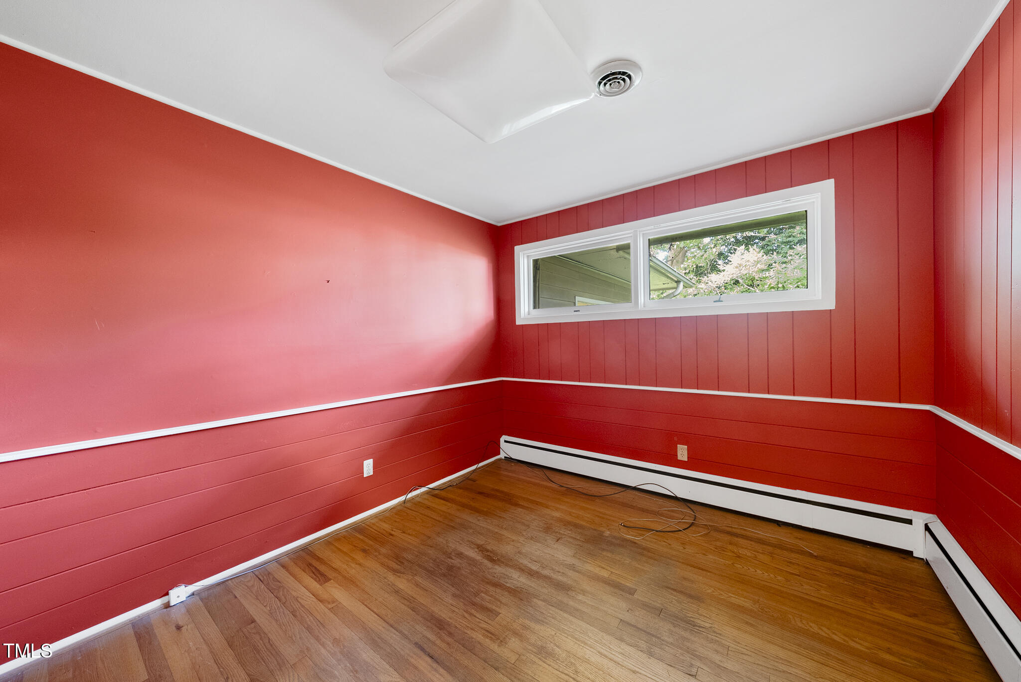 825 Woodburn Road Raleigh, NC 27605 - Photo 23 of 35 a view of a room with wooden floor and a window