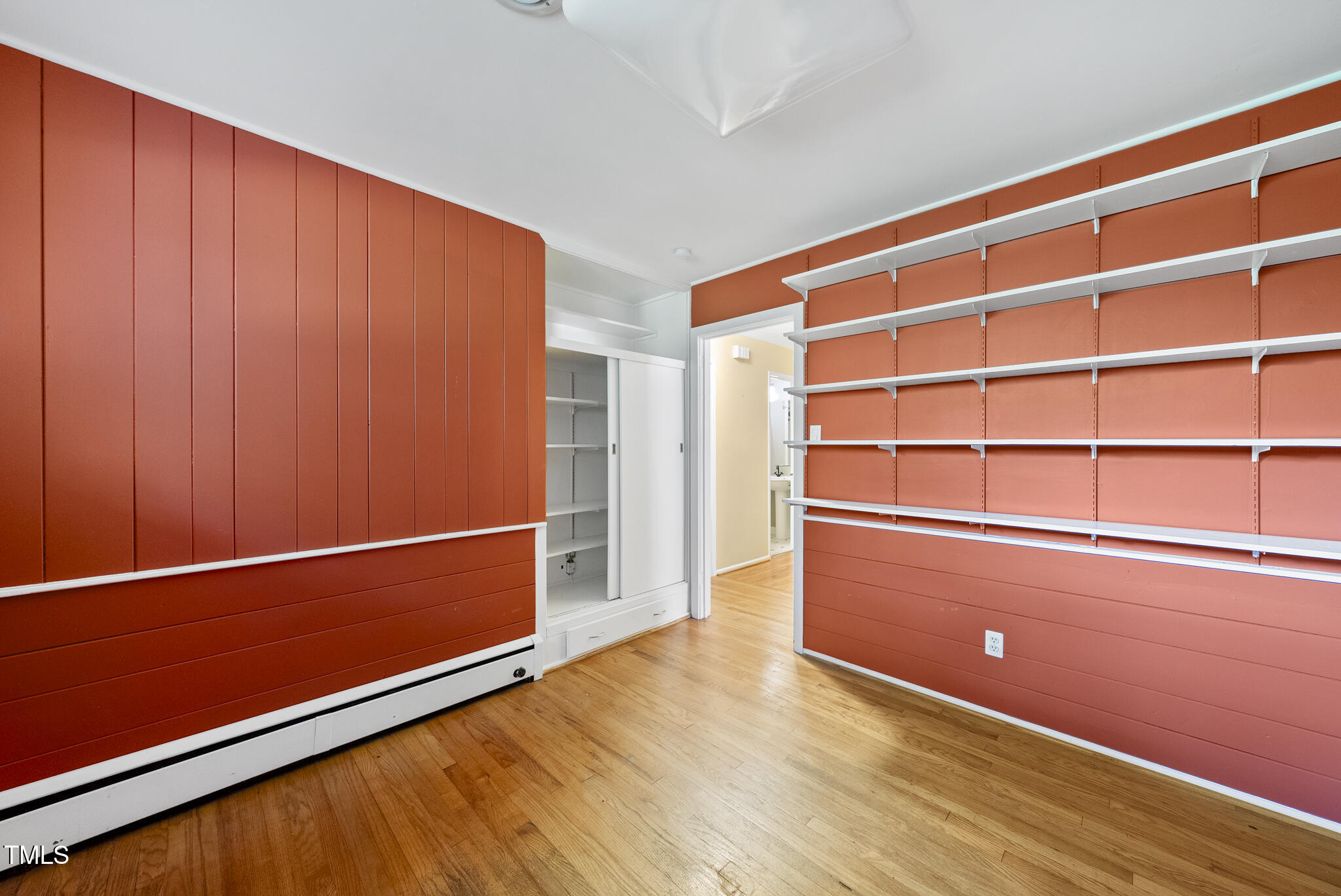 825 Woodburn Road Raleigh, NC 27605 - Photo 24 of 35 a room with wooden floor and shoes