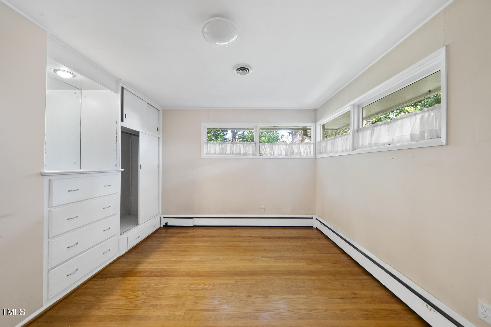 825 Woodburn Road Raleigh, NC 27605 - Photo 26 of 35 wooden floor in an empty room with a window