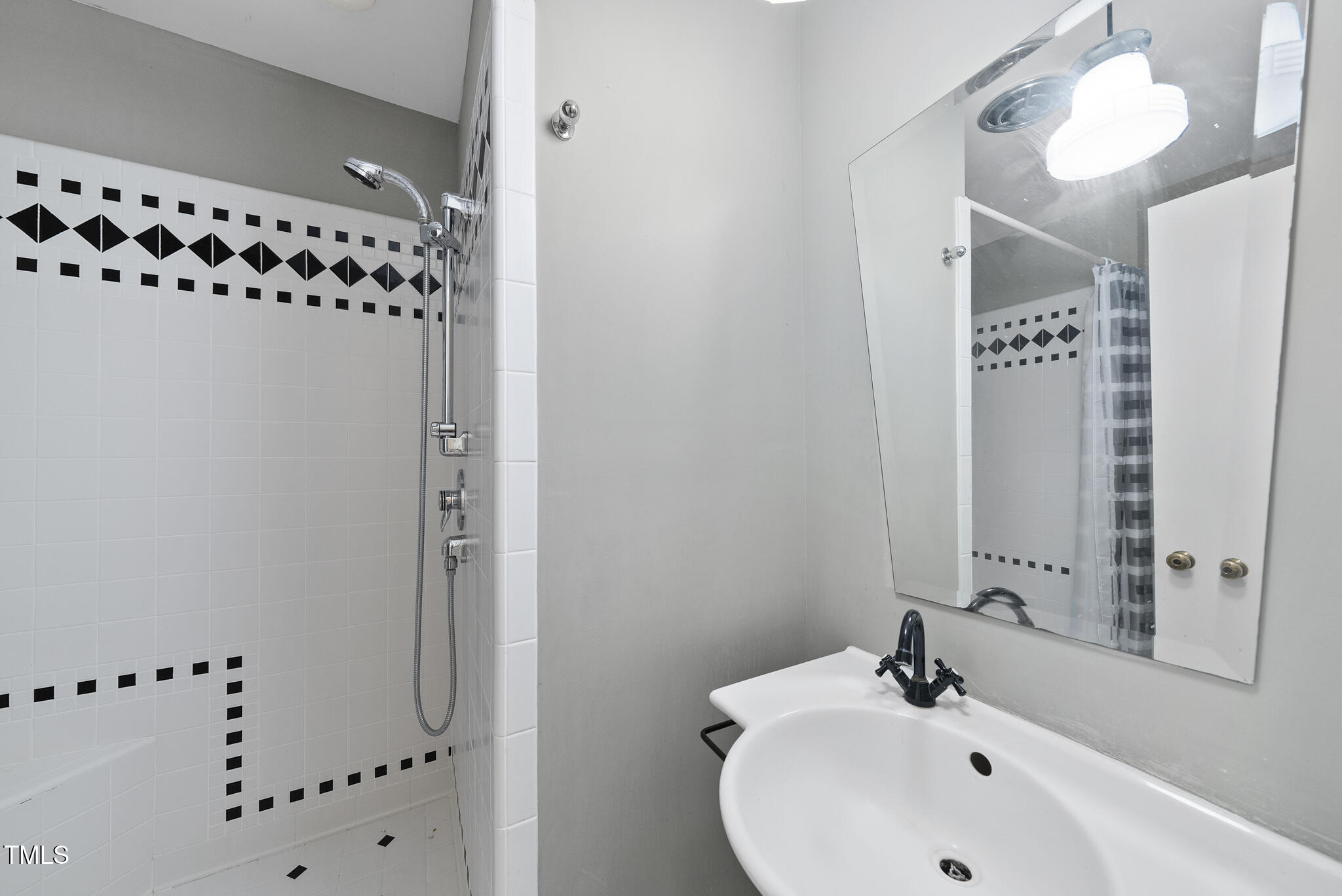 825 Woodburn Road Raleigh, NC 27605 - Photo 27 of 35 a bathroom with a shower and a sink