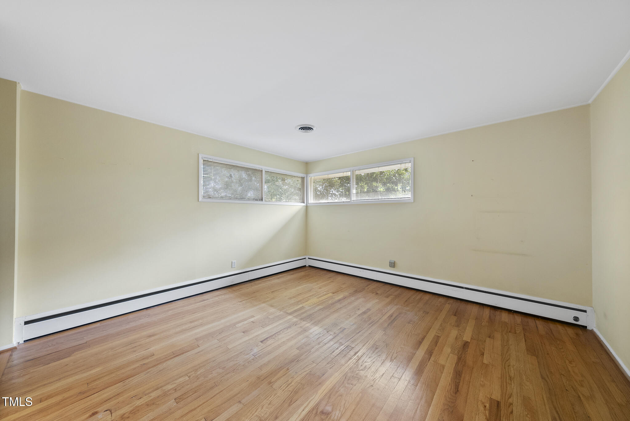 825 Woodburn Road Raleigh, NC 27605 - Photo 28 of 35 a view of an empty room with wooden floor