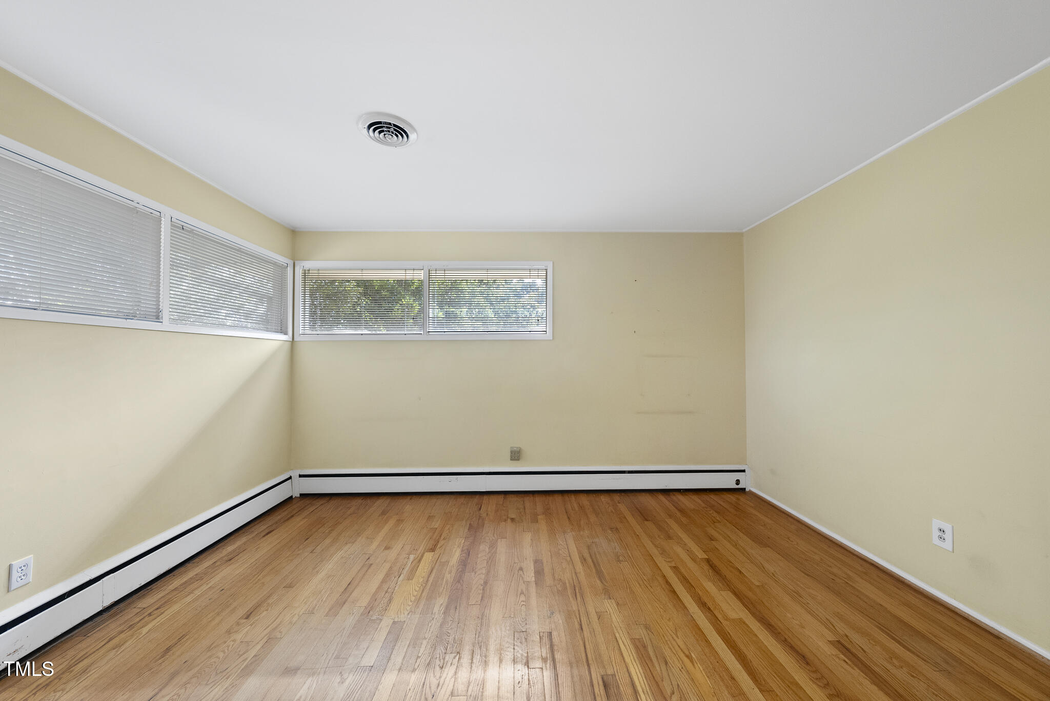 825 Woodburn Road Raleigh, NC 27605 - Photo 29 of 35 an empty room with wooden floor and windows