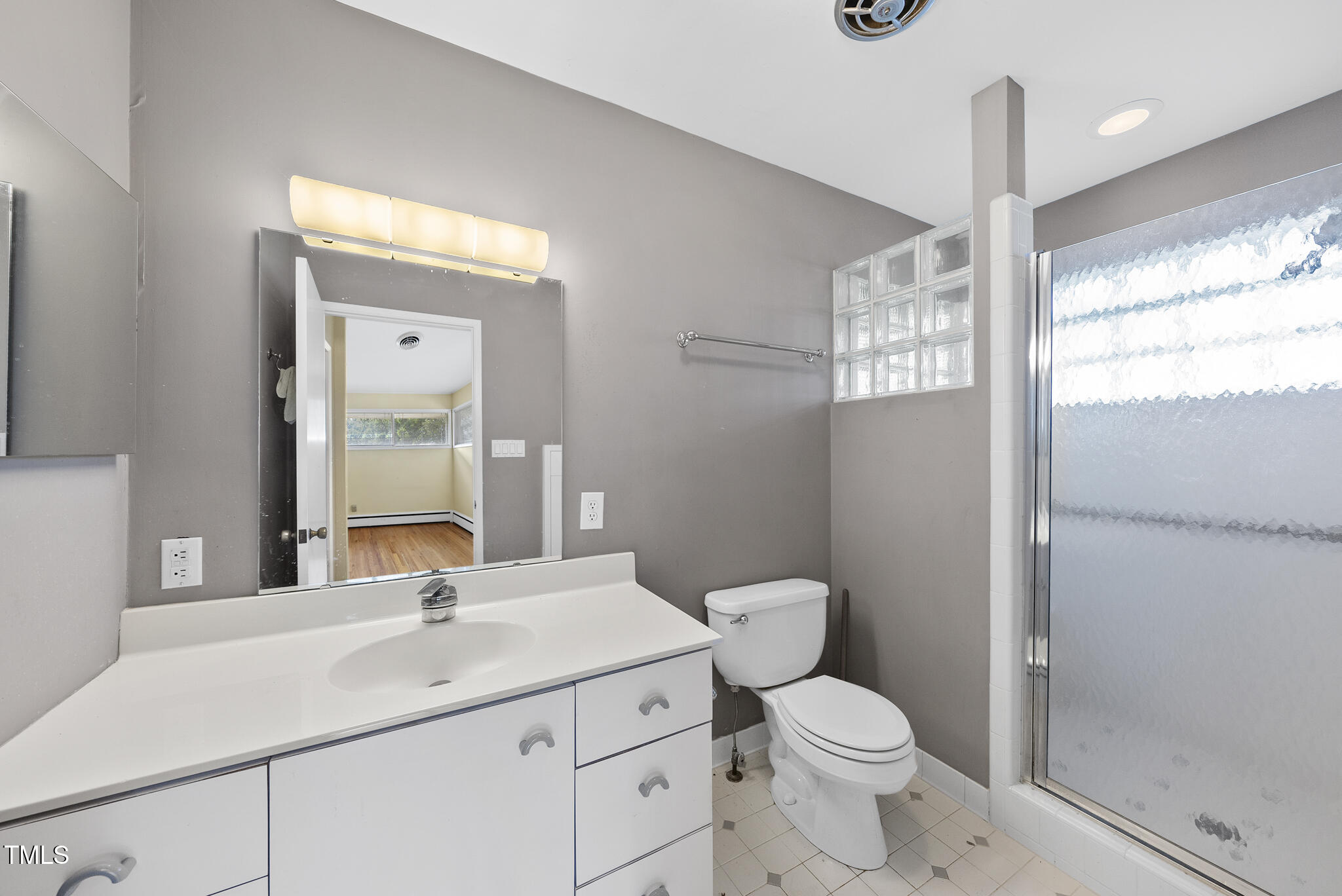 825 Woodburn Road Raleigh, NC 27605 - Photo 31 of 35 a bathroom with a toilet sink and mirror