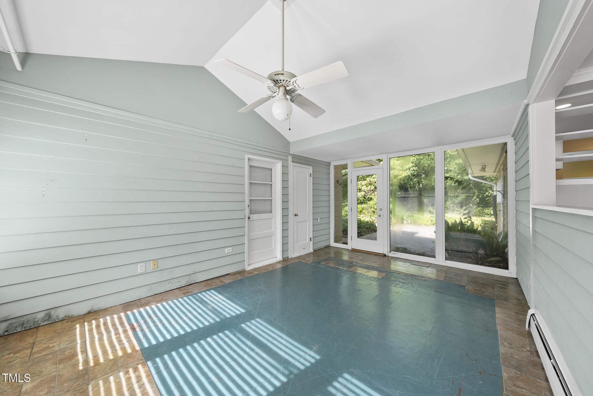 825 Woodburn Road Raleigh, NC 27605 - Photo 32 of 35 a view of a livingroom with wooden floor and a ceiling fan
