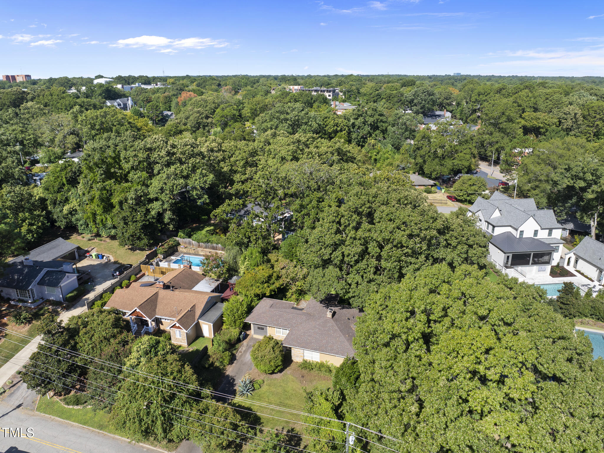 825 Woodburn Road Raleigh, NC 27605 - Photo 4 of 35 an aerial view of residential houses with outdoor space and trees