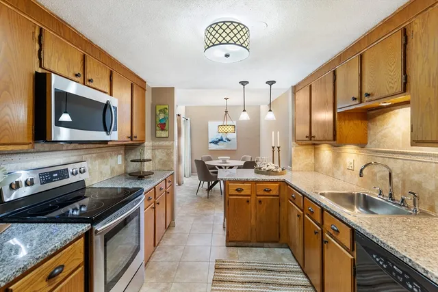 a kitchen with a sink stove and microwave