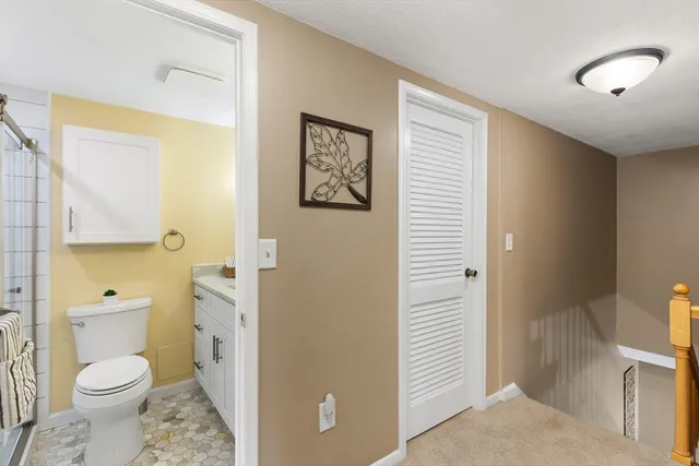 a bathroom with a toilet sink and a mirror