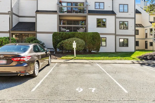 a view of a cars park in front of a building