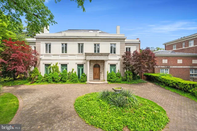 a front view of a house with garden and porch