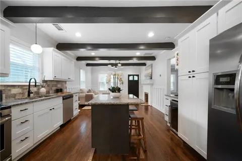 a kitchen with sink stove and refrigerator