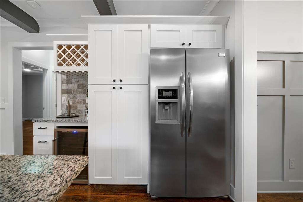 1045 Moreland Avenue Southeast Atlanta, GA 30316 - Photo 12 of 28 a kitchen with a refrigerator and white cabinets