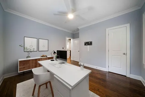 a view of a workspace with furniture and wooden floor