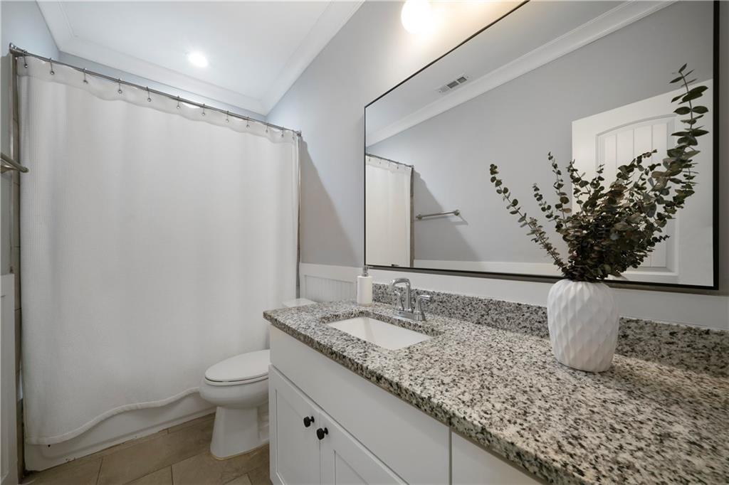 1045 Moreland Avenue Southeast Atlanta, GA 30316 - Photo 23 of 28 a bathroom with a granite countertop sink and a mirror