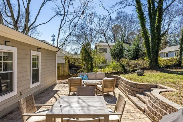 a view of a patio with table and chairs and potted plants