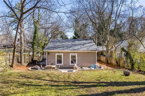 a view of a house with a yard covered in snow