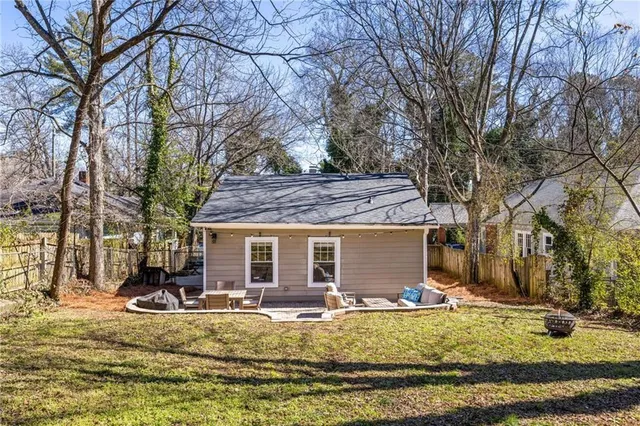 a view of a house with a yard covered in snow