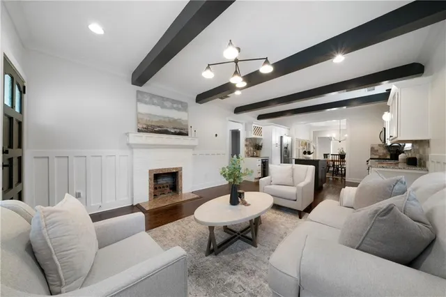 a living room with furniture fireplace and a large window