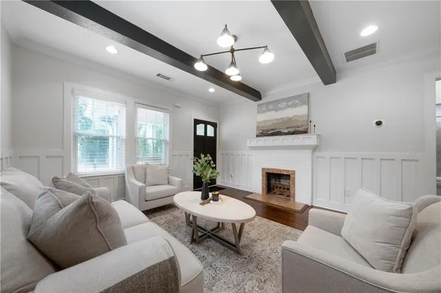 a living room with furniture and a fireplace