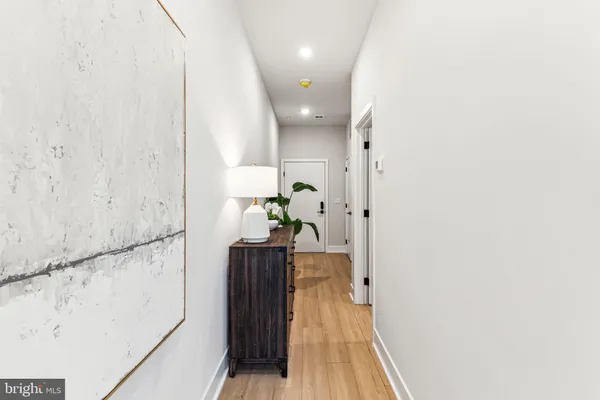 a view of hallway with wooden floor