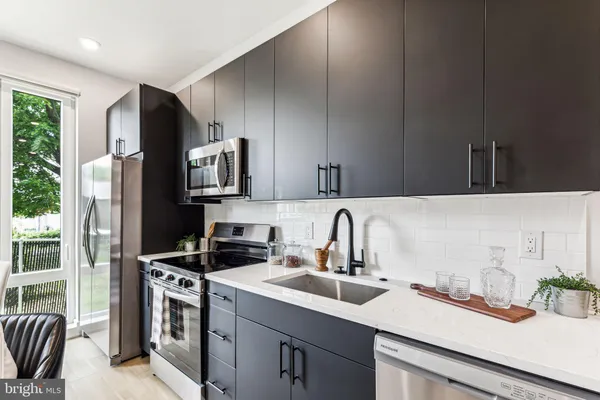 a kitchen with a sink stove and refrigerator