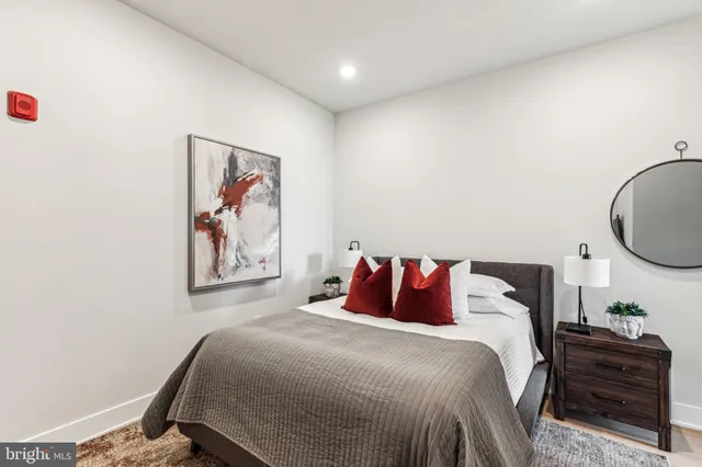 a bedroom with a bed and a painting on the wall