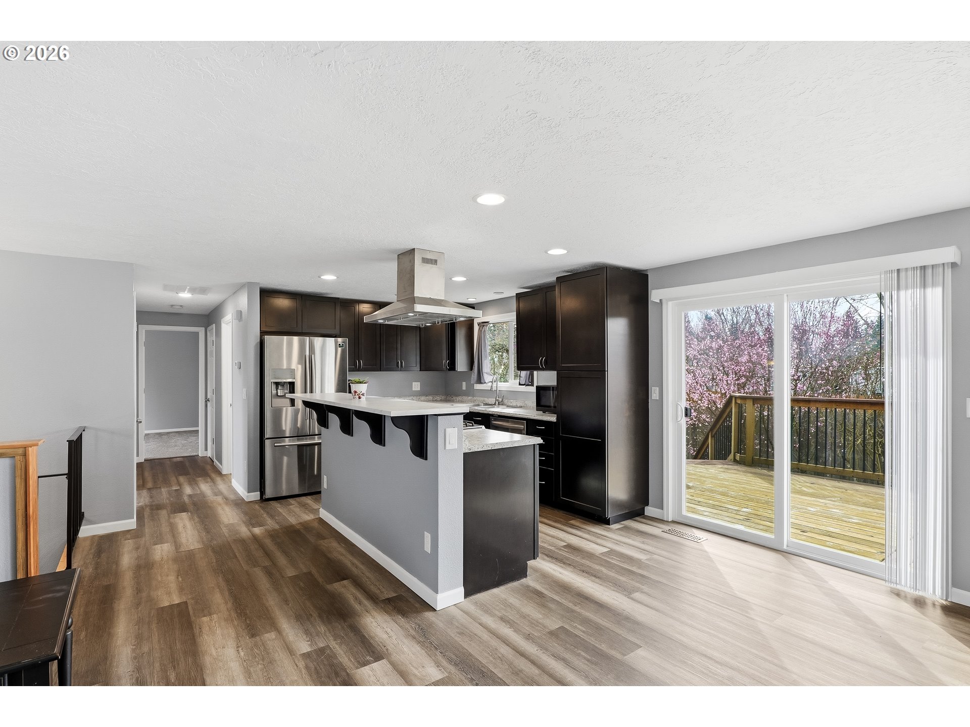 818 Chehalis Place North Keizer, OR 97303 - Photo 5 of 20 a open kitchen with stainless steel appliances kitchen island granite countertop a refrigerator a stove a sink dishwasher and wooden cabinets with large window