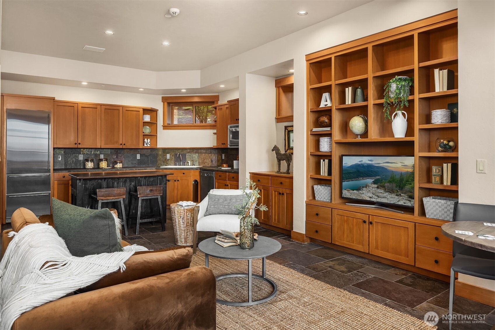 7010 North Mercer Way Mercer Island, WA 98040 - Photo 30 of 40 a living room with furniture a flat screen tv and floor to ceiling window