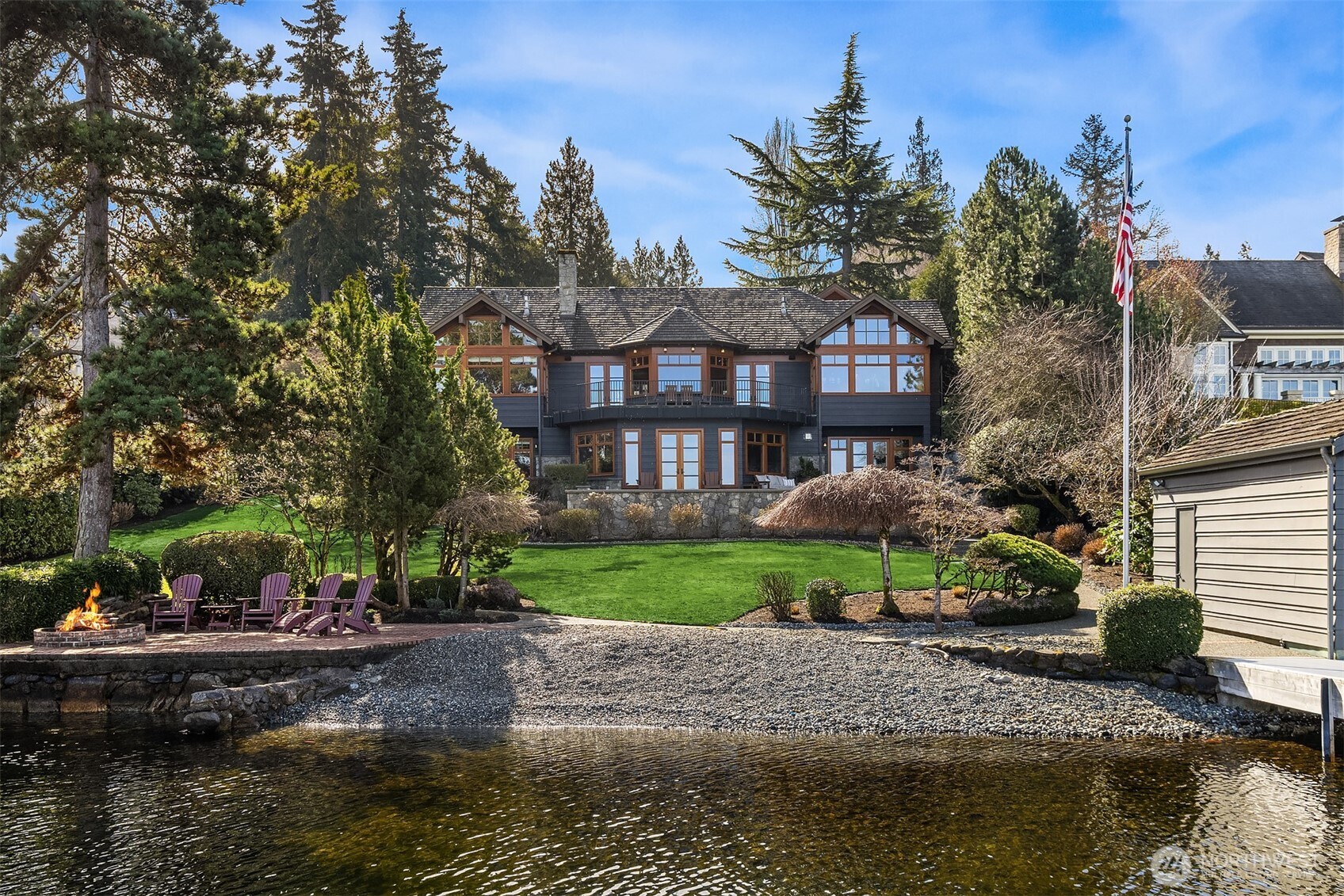 7010 North Mercer Way Mercer Island, WA 98040 - Photo 40 of 40 a front view of a house with a garden and lake view