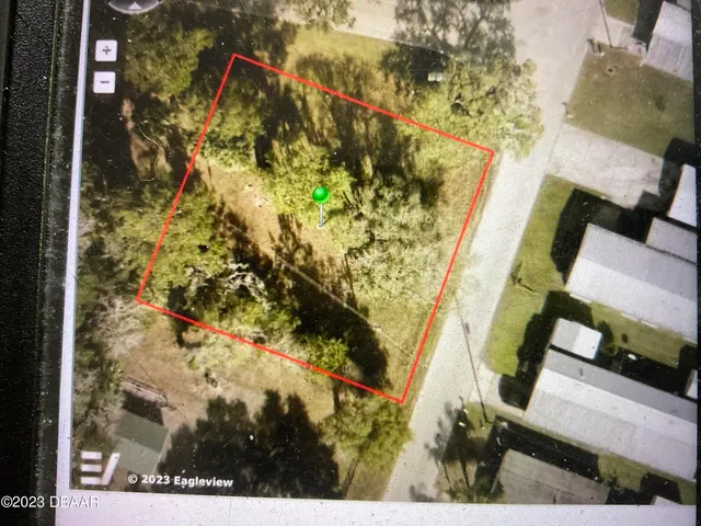 a view of a grassy field with trees