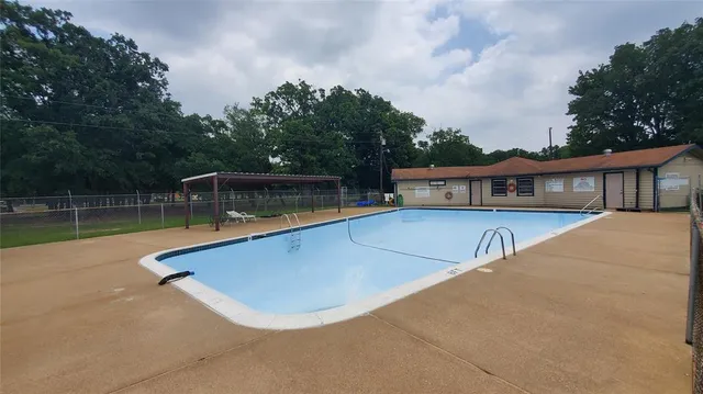 a view of a house with swimming pool and sitting area