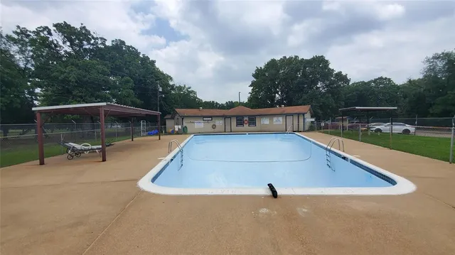 a view of a swimming pool with chairs