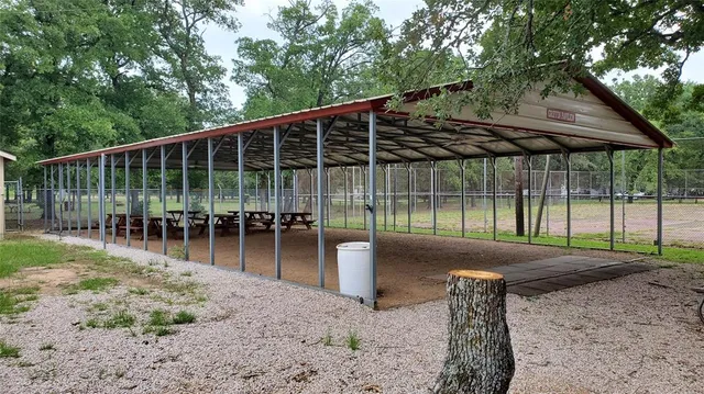a view of a backyard with floor to ceiling window and wooden fence