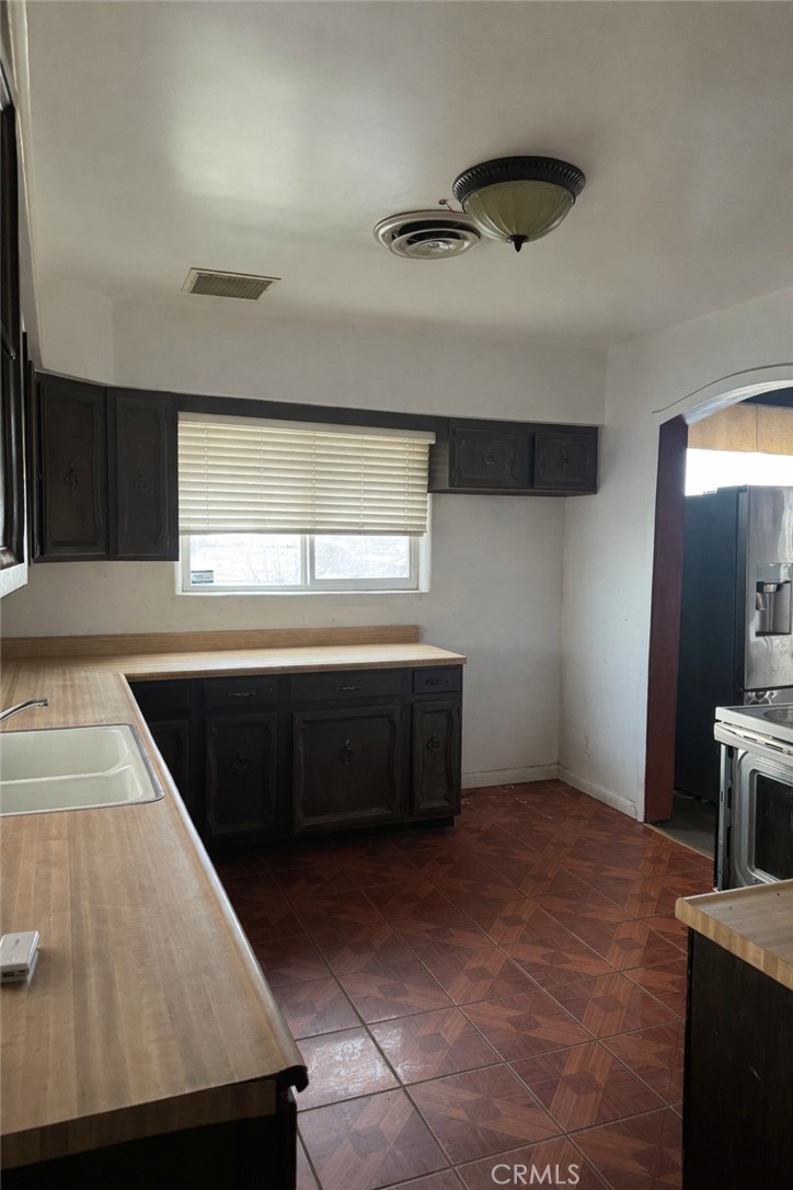 19859 Anahola Road Barstow, CA 92311 - Photo 2 of 14 a kitchen with a stove and a refrigerator